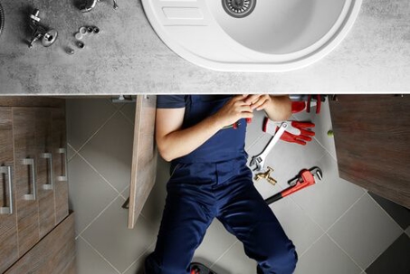Plumber fixing sink